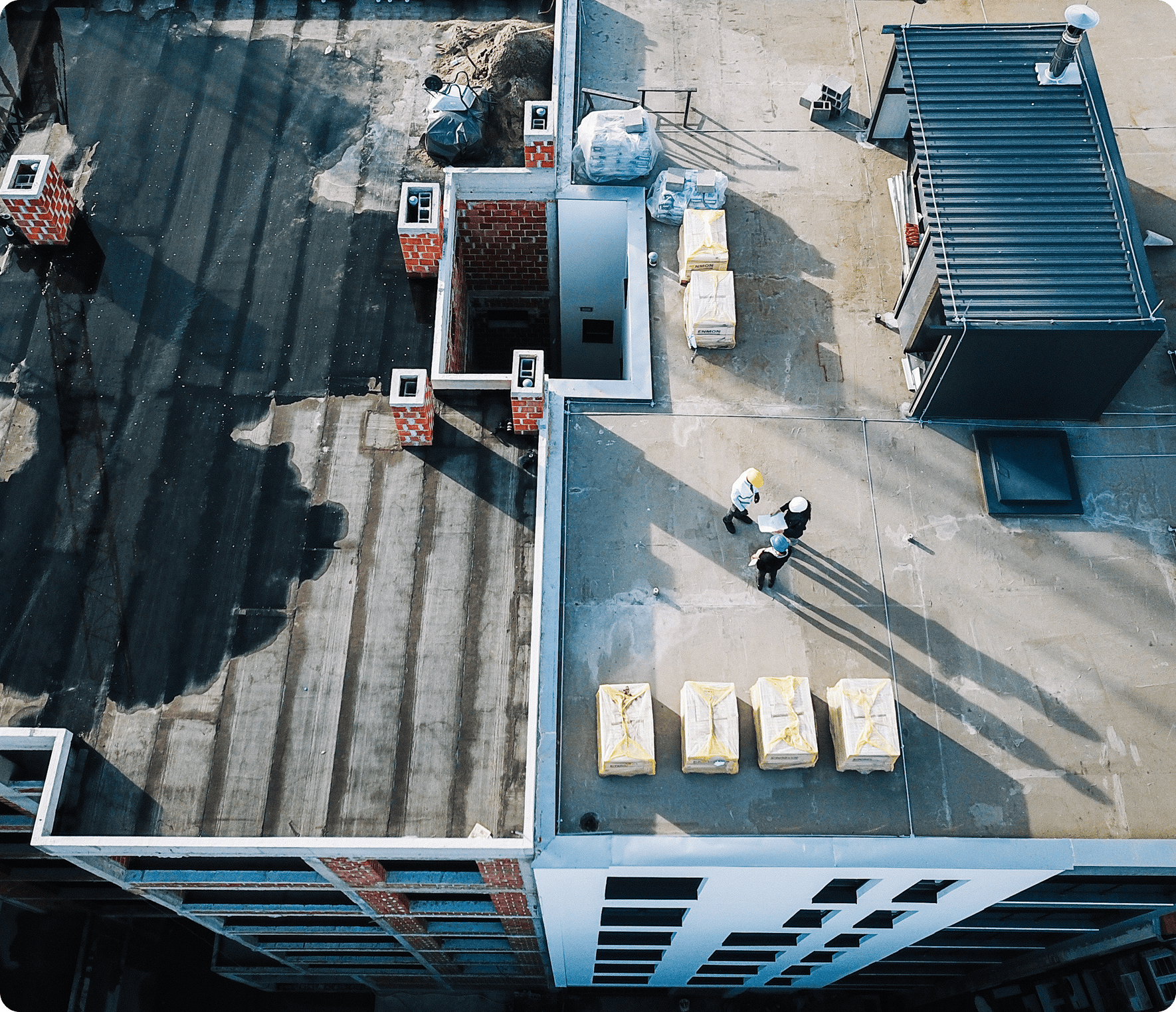 Workers on urban rooftop construction site